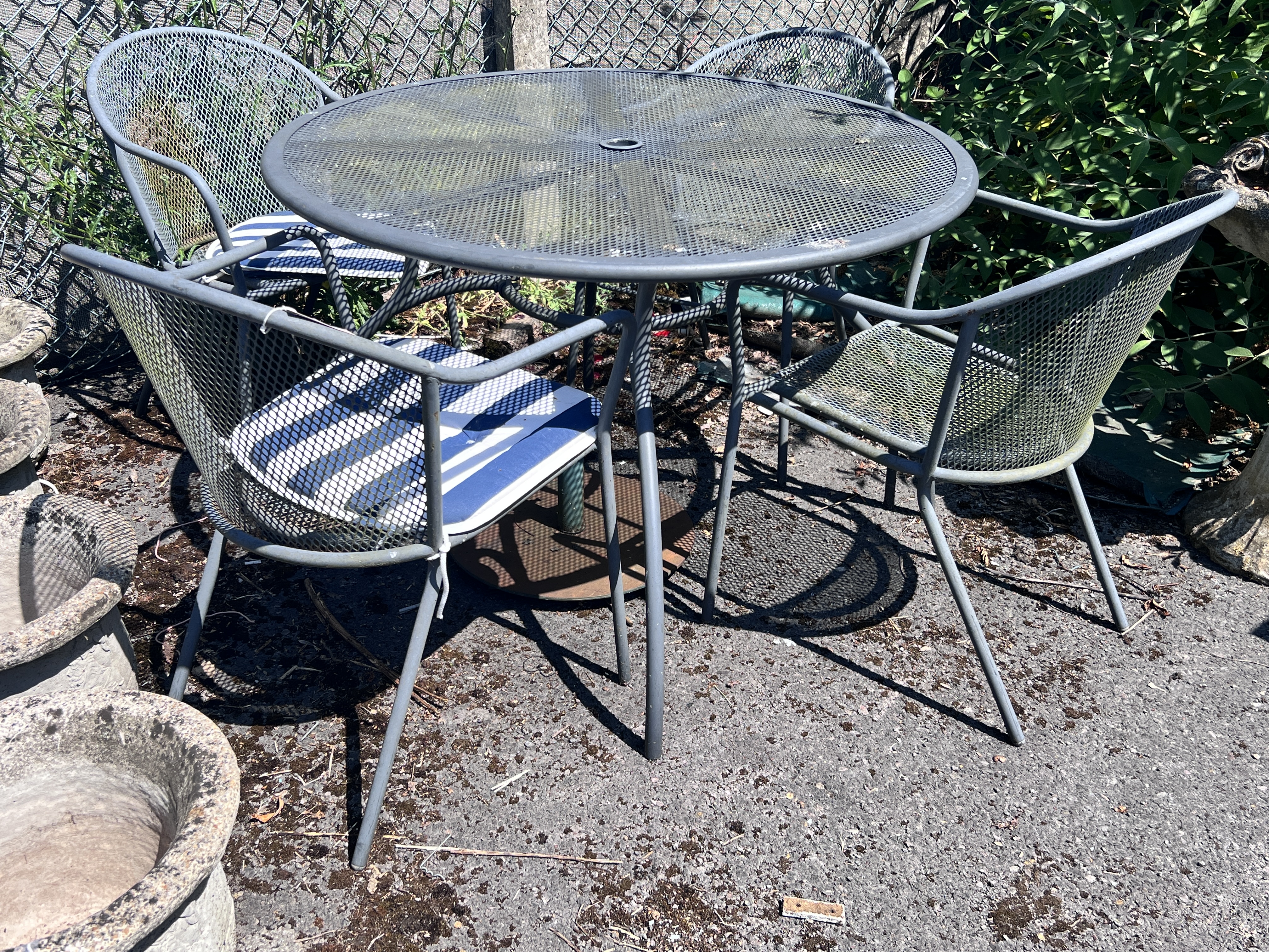 A Kettler circular metal garden table, diameter 110cm, height 72cm, and four chairs